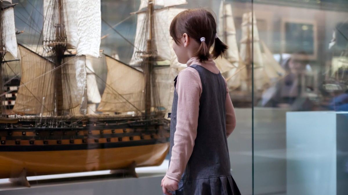 A child looking at exhibits in a museum.