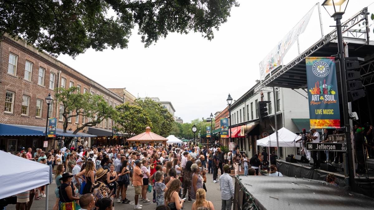 A large crowd of people enjoying an outdoor festival.