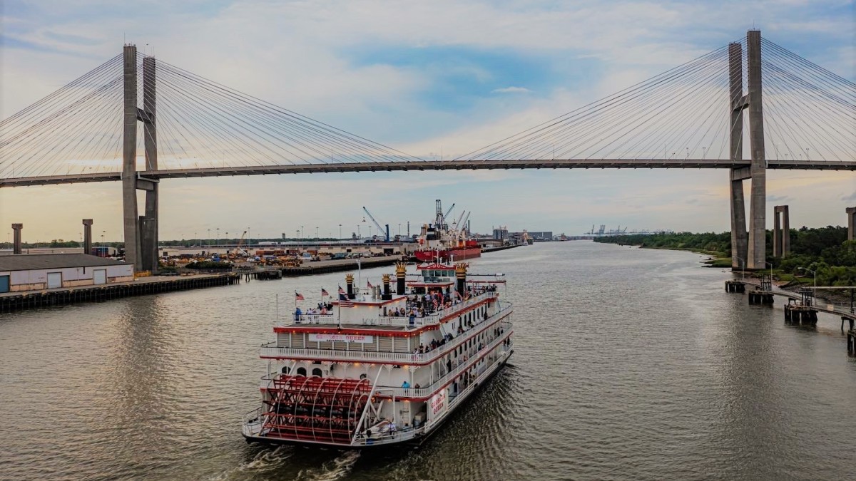 Riverboat cruise in Savannah traveling under a bridge.