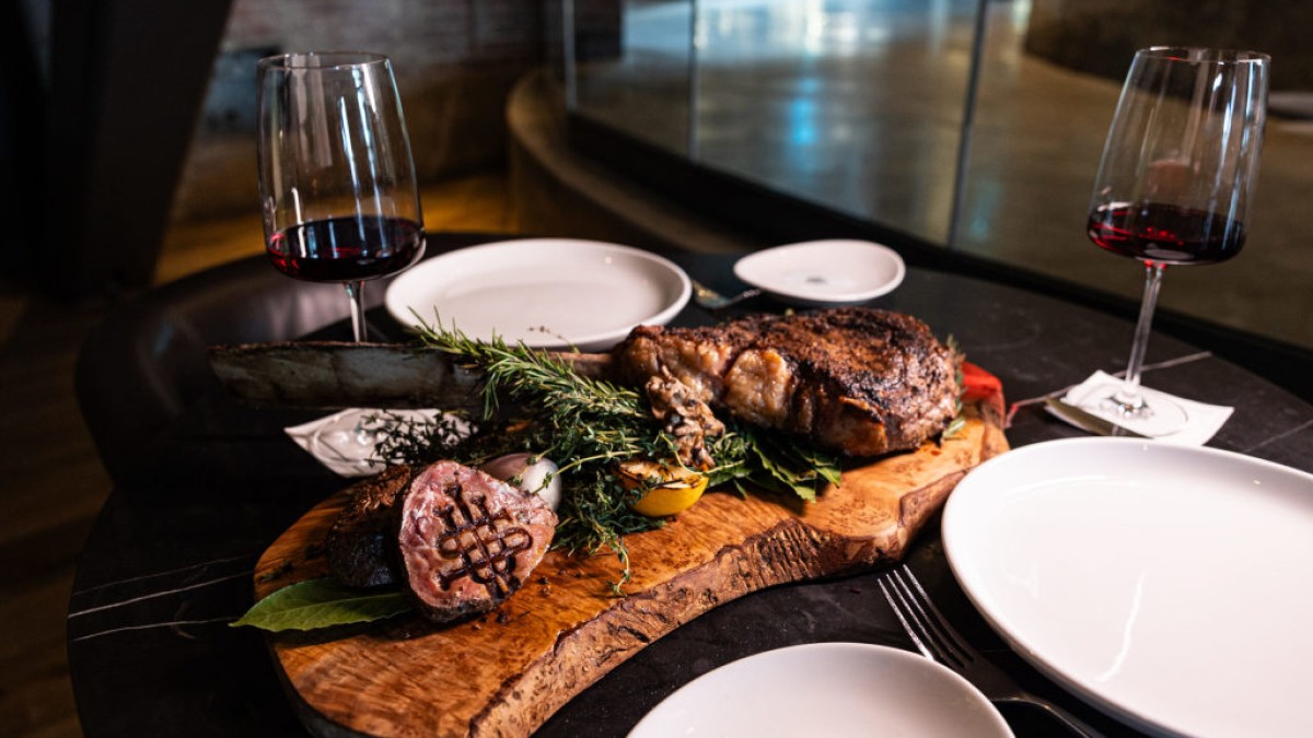 Steak served on a wooden platter.