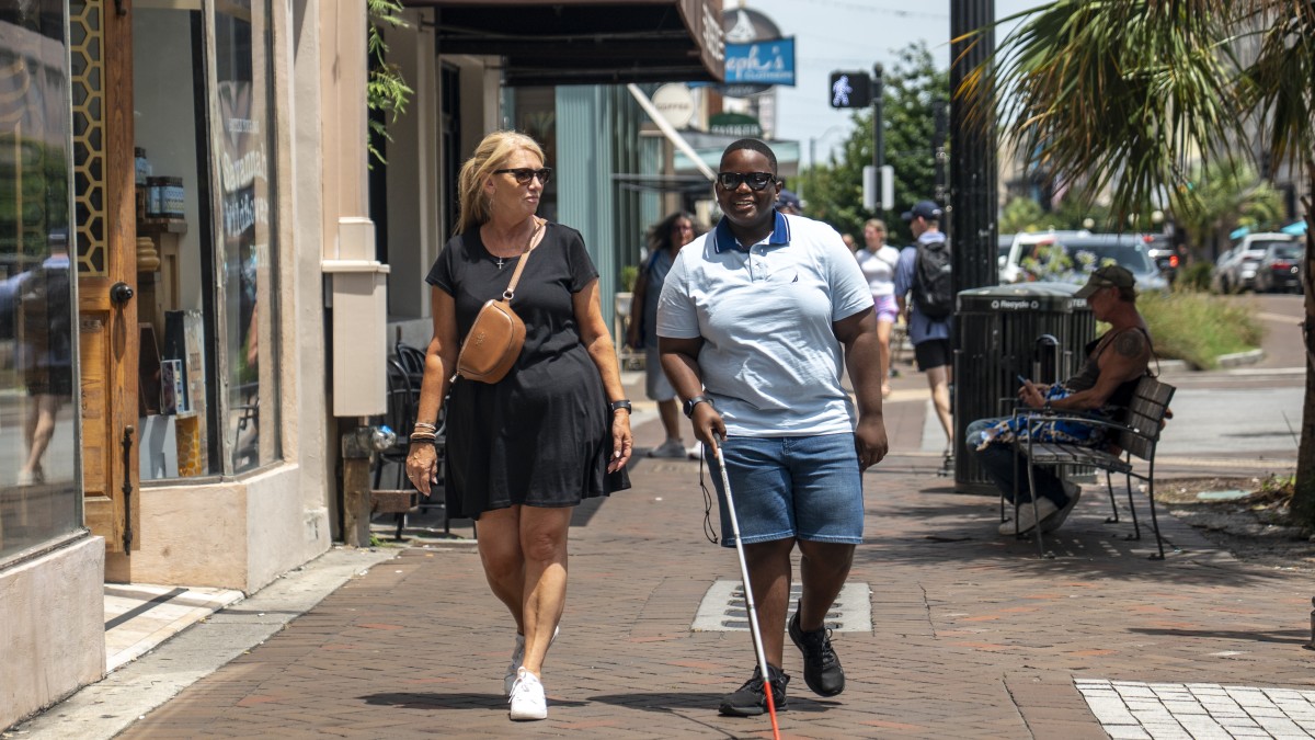 Blind walker and companion on Broughton Street