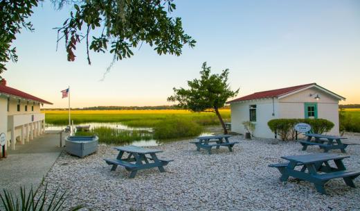 Picnic tables at Pin Point Heritage Museum Sunset on the Moon River at Pin Point Heritage Museum in Savannah, Georgia.