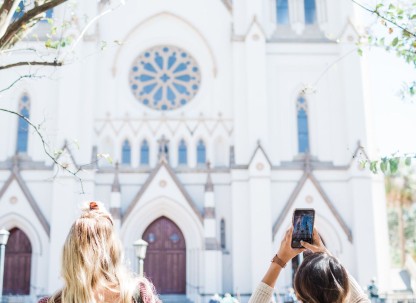 The Cathedral of St. John the Baptist is an iconic architectural masterpiece. Visitors snap photos of the Cathedral of St. John the Baptist