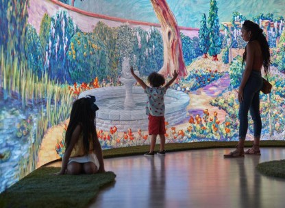 A child ineracting with an immersive wall painting in a museum.