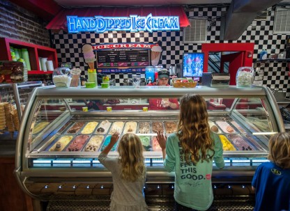 Kids looking at ice cream at River Street Sweets in Savannah, Georgia.